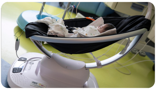 An infant sleeps in a Mamaroo funded by CMN at Penn State Health Children's Hospital