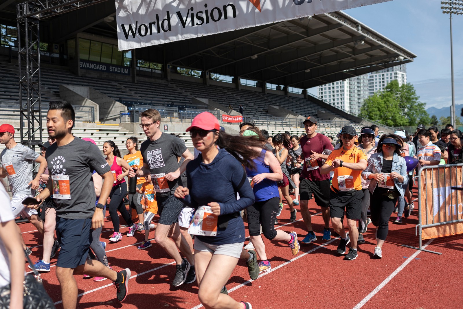 people running on a track to raise money for clean water